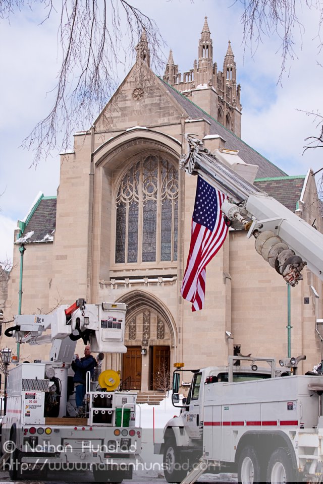 A flag hangs from a cherry picker in front of the House of Hope Presbyterian Church on Summit Avenue